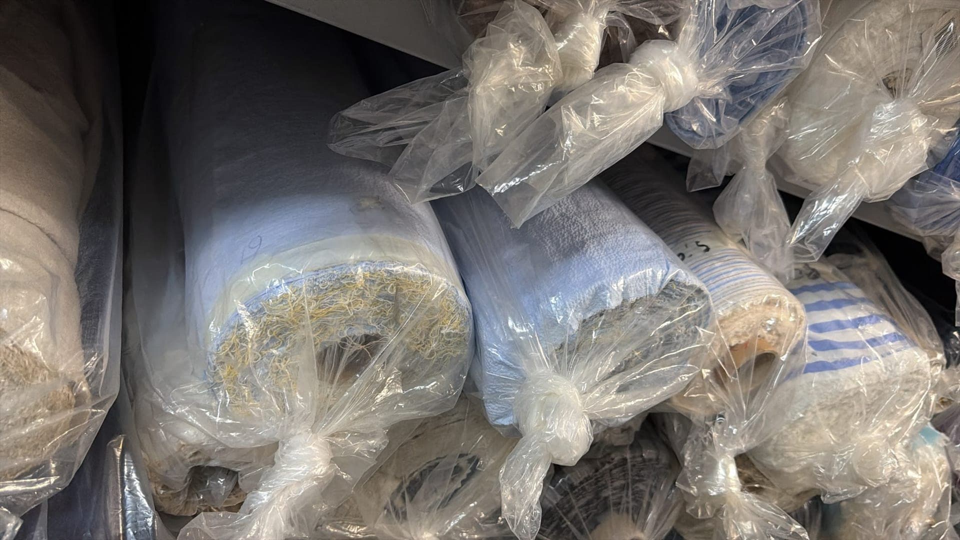 Plastic wrapped fabric rolls warehouse